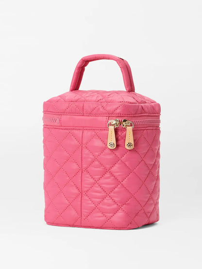 Pink quilted nylon MZ Wallace Large Vanity Case in Zinnia Oxford with a gold zipper and top handle, standing upright against a white background.