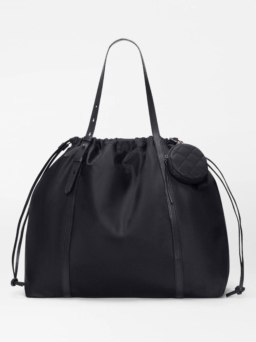 The MZ Wallace Large Waverly Tote in Black Bedford features drawstring sides, slim Italian leather handles, and a small quilted pouch. It's spacious enough for a 15" laptop—perfect for carrying work or travel essentials.