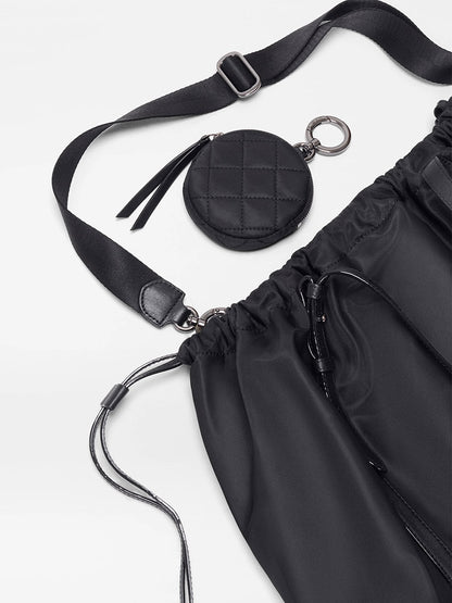 The MZ Wallace Large Waverly Tote in Black Bedford features a nylon crossbody strap, adjustable drawstring closure, and an attached round quilted coin pouch on a light background.