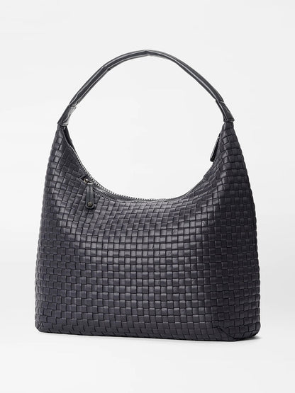 The MZ Wallace Large Woven Shoulder Bag in Black Oxford, featuring a curved handle and top zipper closure, perfect for daily organization, displayed against a plain white background.