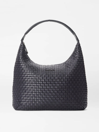 The MZ Wallace Large Woven Shoulder Bag in Black Oxford is a stylish and practical accessory, featuring a black woven leather design with a curved top handle, zip closure, and a small logo centrally positioned. Ideal for daily organization, this lightweight shoulder bag effortlessly merges elegance with functionality.