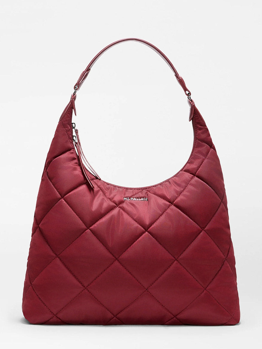 Introducing the MZ Wallace Madison Shoulder in Claret Bedford—a spacious, quilted shoulder bag crafted from recycled Bedford nylon in a rich claret hue, featuring diamond stitching, a curved Italian leather handle, and a subtle metal logo plate on the front.