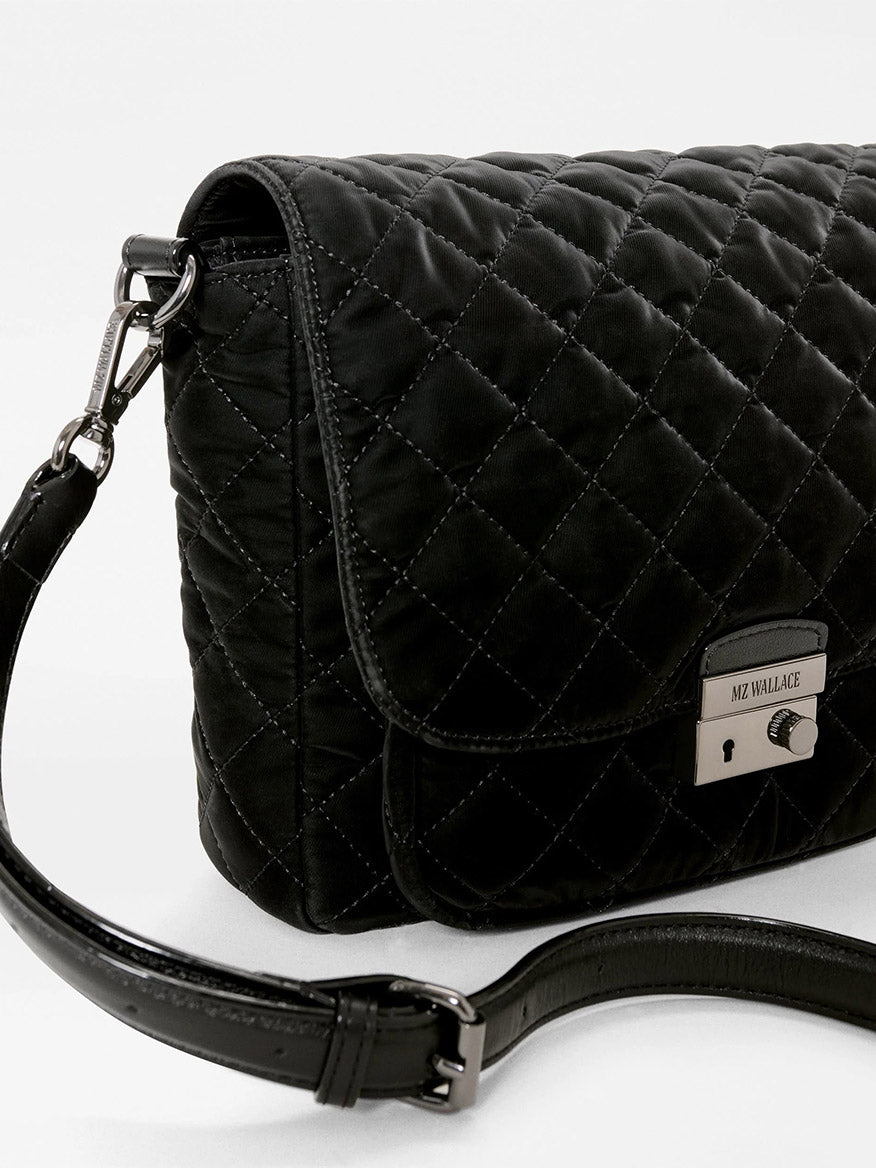 Black quilted MZ Wallace Crosby Lock Medium Crossbody bag in a velvet finish with metal lock hardware and an adjustable shoulder strap.