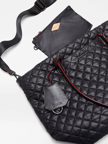 MZ Wallace Medium Daily Tote in Black Oxford, featuring quilted recycled nylon, an adjustable shoulder strap, red accents, an attached leather tag, and a matching zippered pouch, displayed on a white background.