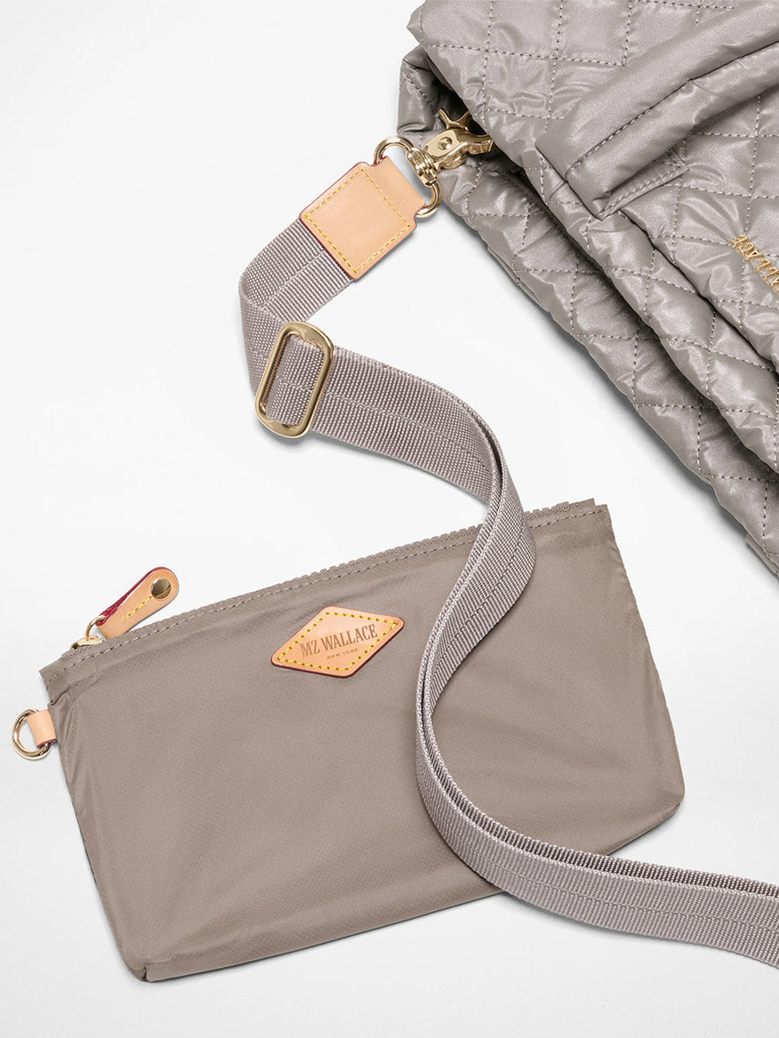The MZ Wallace Medium East West Metro Tote in Sable Pearl Metallic Oxford is displayed next to a matching quilted bag, both featuring elegant leather accents and Italian leather trim.