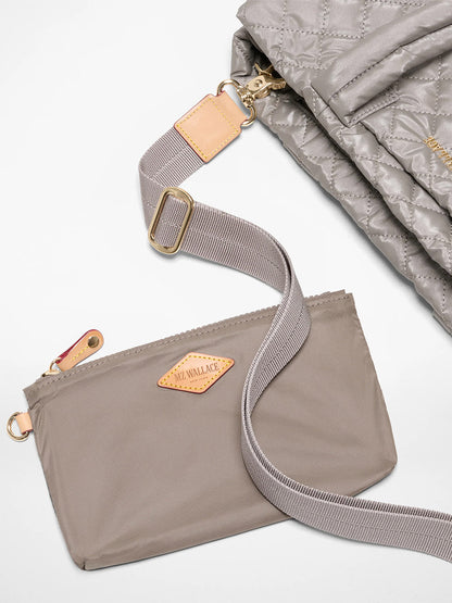 The MZ Wallace Medium East West Metro Tote in Sable Pearl Metallic Oxford is displayed next to a matching quilted bag, both featuring elegant leather accents and Italian leather trim.