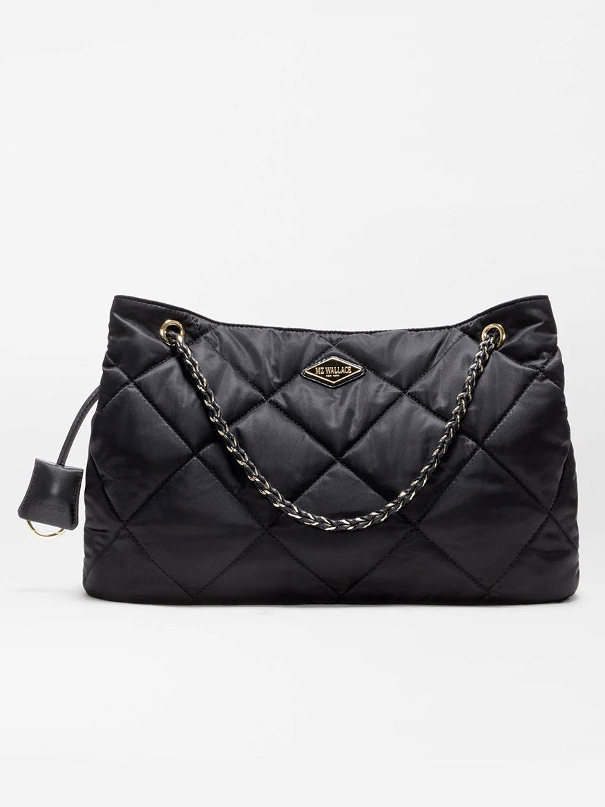 Introducing the MZ Wallace Medium Frankie Tote in Black Bedford—a black quilted nylon tote accented with gold chain straps and gold-tone hardware, featuring a signature triangular metal logo plate on the front. This versatile bag combines timeless style and everyday elegance.