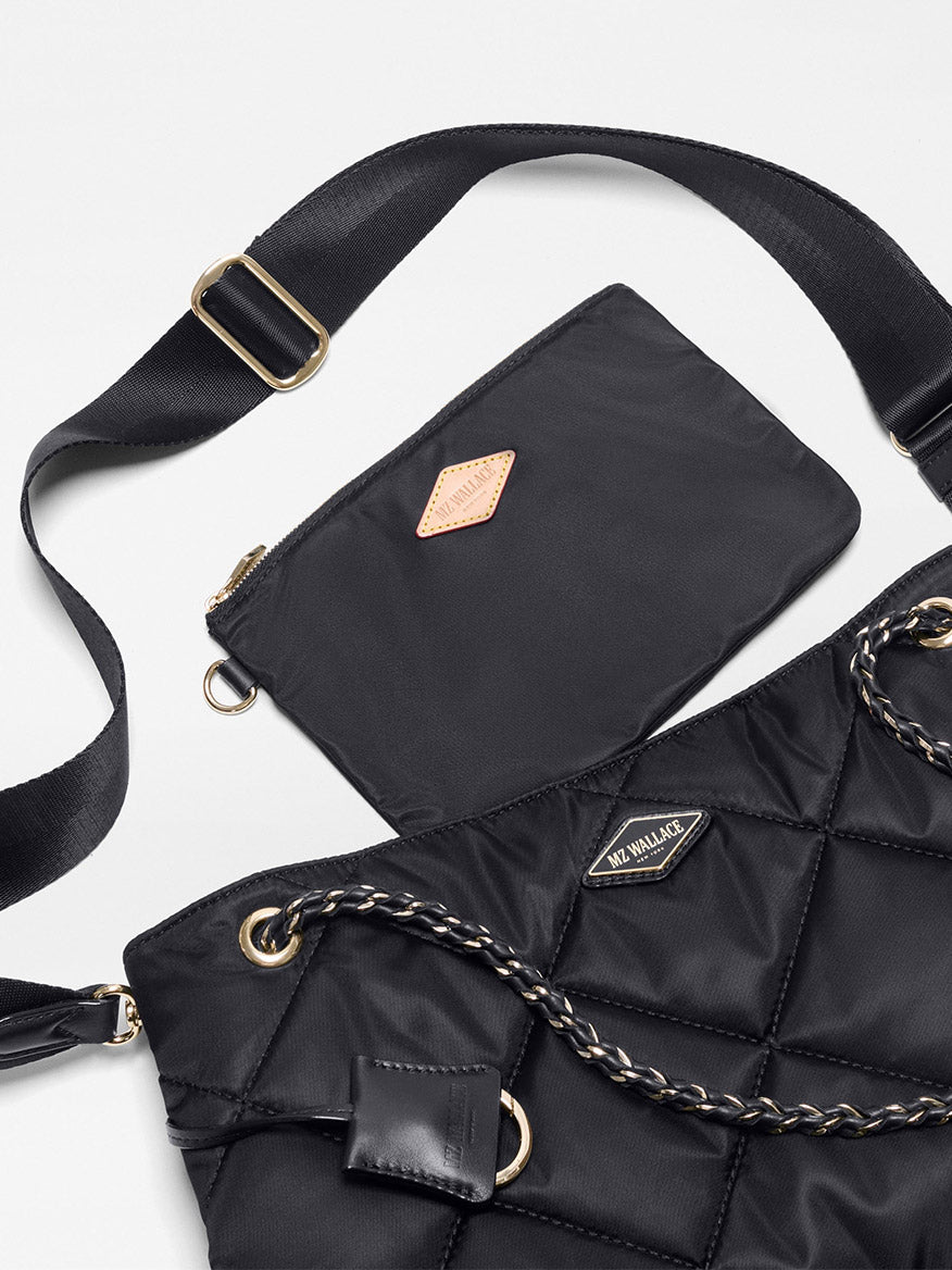 The MZ Wallace Medium Frankie Tote in Black Bedford, displayed on a white background, features elegant chain straps, an adjustable crossbody strap, and comes with a matching black zippered pouch.