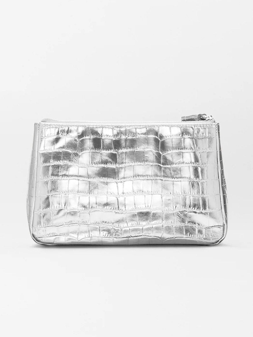 The MZ Wallace Medium Luna Cosmetic in Silver Croc Effect is a rectangular metallic silver leather bag with a crocodile texture and zip-top closure, set against a plain light background.