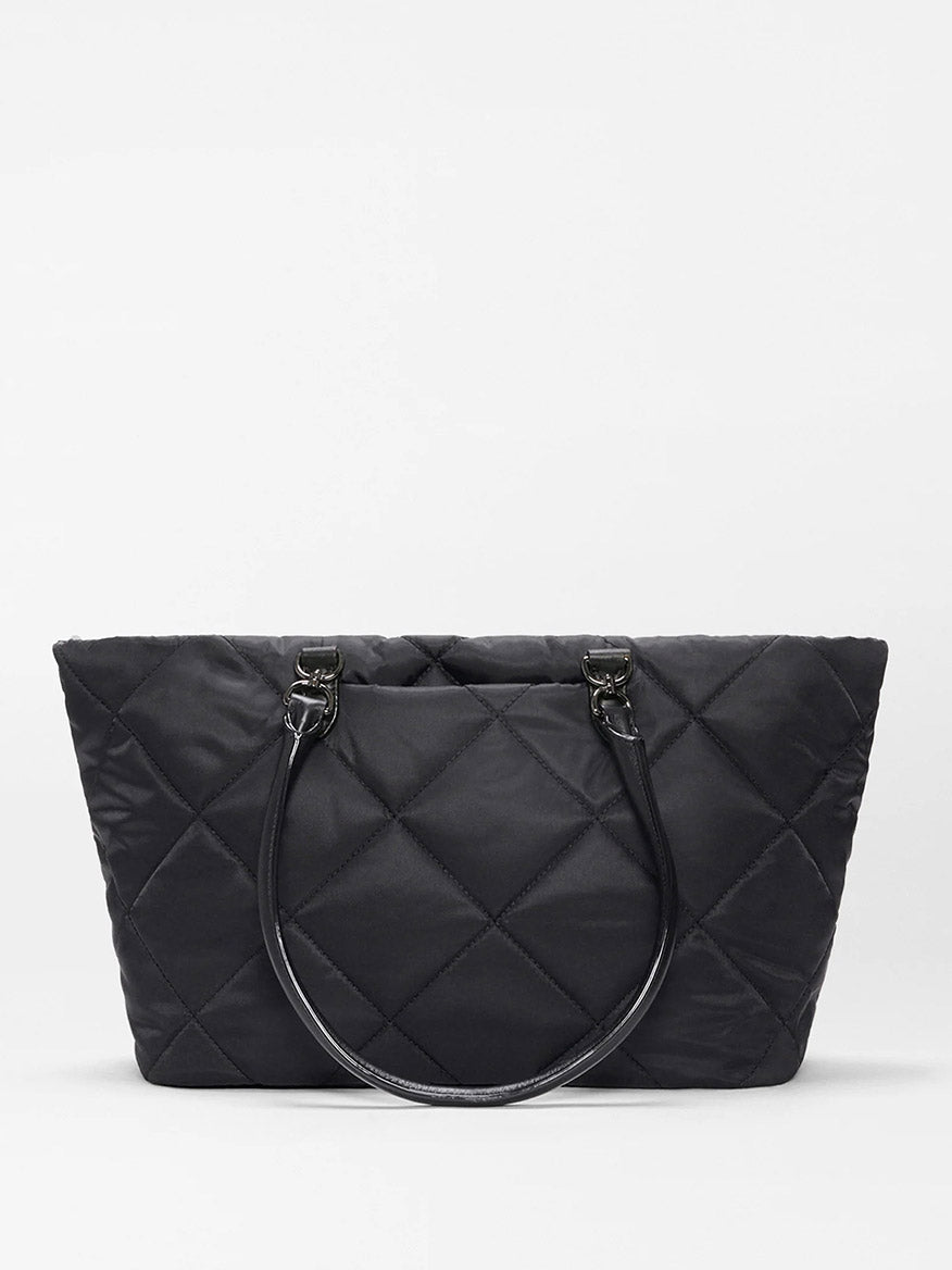 The MZ Wallace Medium Madison E-W Tote in Black Bedford features double handles and an adjustable nylon crossbody strap, shown against a white background.