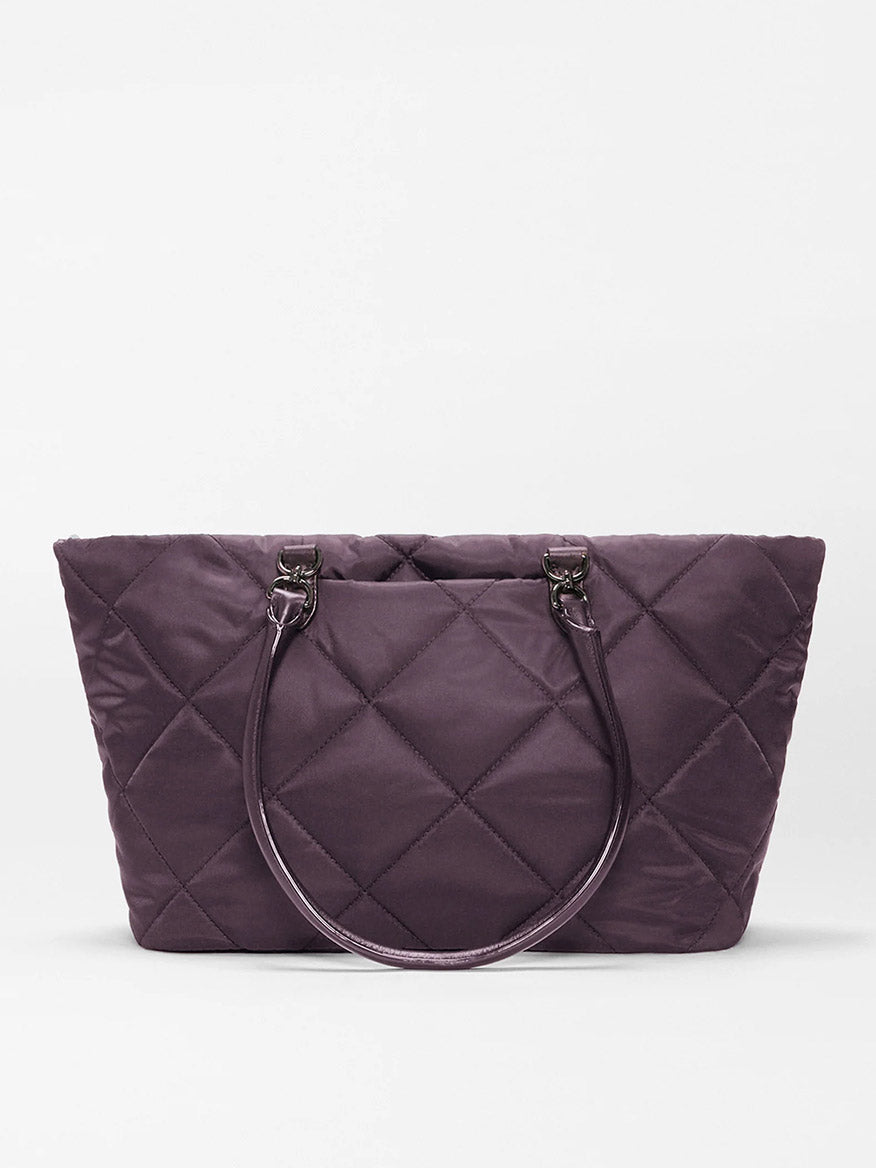 The MZ Wallace Medium Madison E-W Tote in Raisin Oxford, a purple quilted nylon bag with two matching handles, is displayed against a plain white background.
