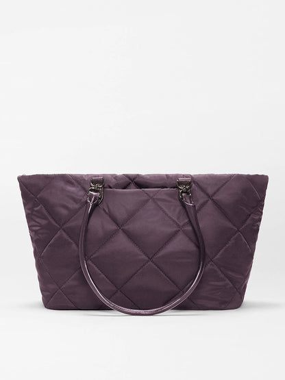 The MZ Wallace Medium Madison E-W Tote in Raisin Oxford, a purple quilted nylon bag with two matching handles, is displayed against a plain white background.