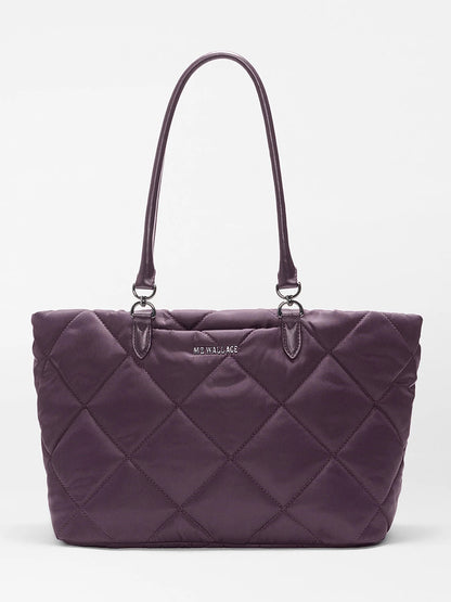 MZ Wallace Medium Madison E-W Tote in Raisin Oxford: This purple quilted tote bag is crafted from recycled quilted nylon, features double shoulder straps, and displays a silver “MZ WALLACE” logo on the front; shown against a plain white background.