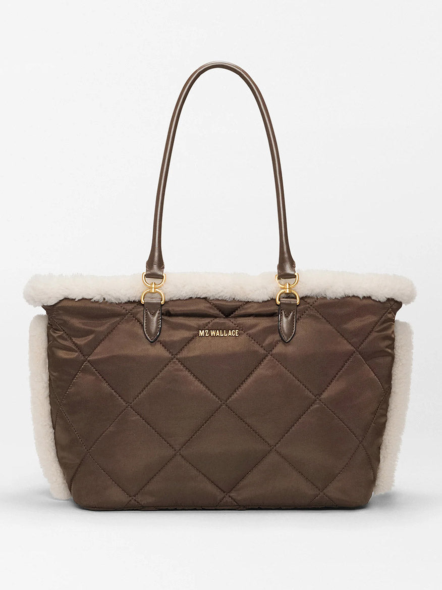 The MZ Wallace Medium Madison E-W Tote in Shearling & Walnut features quilted brown nylon, cream trim, gold hardware, a crossbody strap, and the "MZ WALLACE" logo on the front.