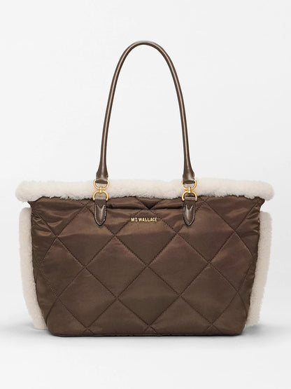 The MZ Wallace Medium Madison E-W Tote in Shearling & Walnut features quilted brown nylon, cream trim, gold hardware, a crossbody strap, and the "MZ WALLACE" logo on the front.