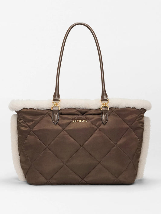 The MZ Wallace Medium Madison E-W Tote in Shearling & Walnut features quilted brown nylon, cream trim, gold hardware, a crossbody strap, and the "MZ WALLACE" logo on the front.