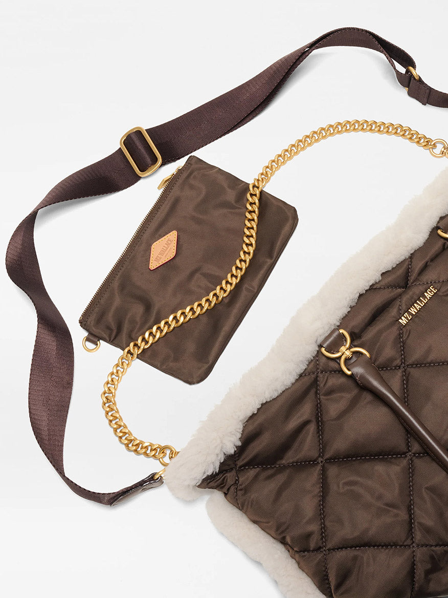 The MZ Wallace Medium Madison E-W Tote in Shearling & Walnut features quilted nylon with white trim, gold chain detail, a matching crossbody strap, and a small brown zip pouch with gold zipper and logo patch.