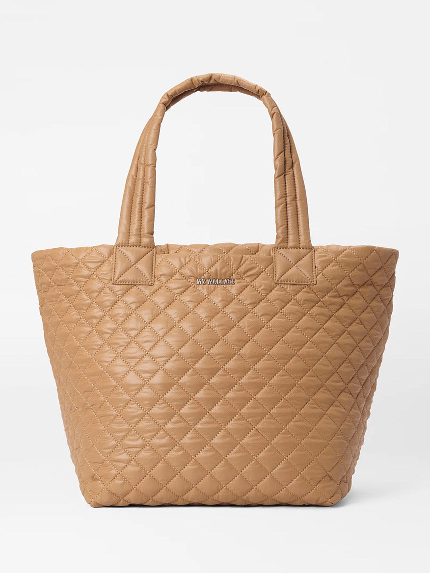 The MZ Wallace Medium Metro Tote Deluxe in Caramel Oxford features a quilted pattern, Italian leather trim, and handles on a white background.