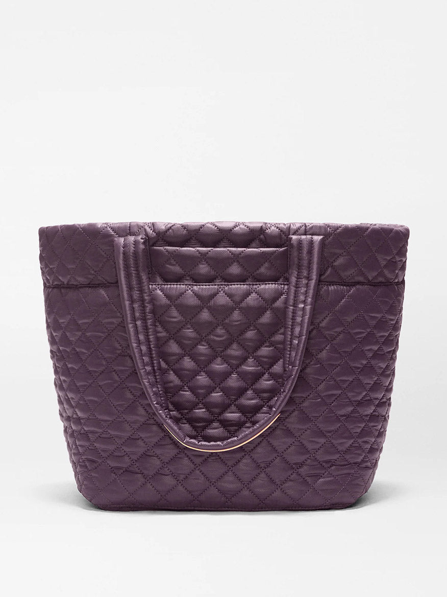 The MZ Wallace Medium Metro Tote Deluxe in Raisin Oxford is a lightweight, quilted bag with double handles, shown standing upright on a plain white background.