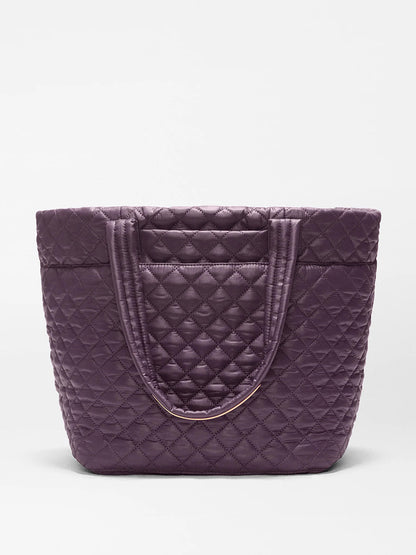 The MZ Wallace Medium Metro Tote Deluxe in Raisin Oxford is a lightweight, quilted bag with double handles, shown standing upright on a plain white background.