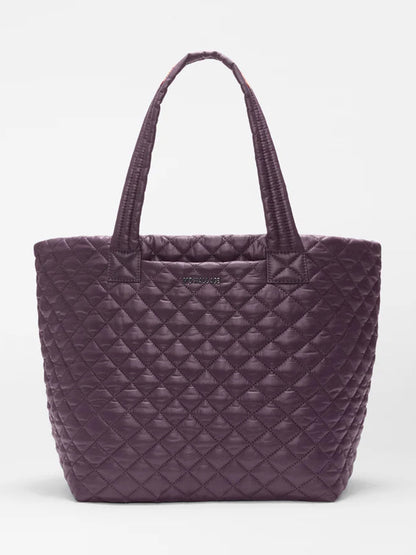 The MZ Wallace Medium Metro Tote Deluxe in Raisin Oxford features a diamond-quilted design, two handles, and a featherlight feel, shown here against a plain white background.