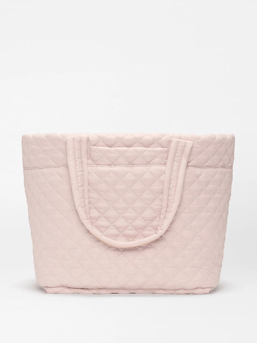 The MZ Wallace Medium Metro Tote Deluxe in City Pink Oxford, made from REC Oxford Fabrication with two handles and a luggage sleeve, is shown against a plain white background.