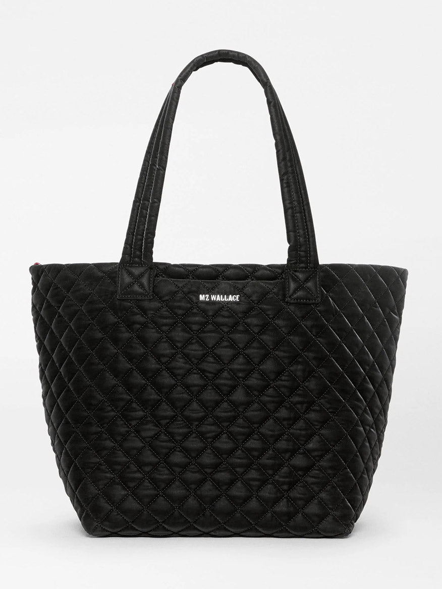 MZ Wallace Medium Metro Tote Deluxe in Black Velvet Finish with two shoulder straps and a logo patch on the front.
