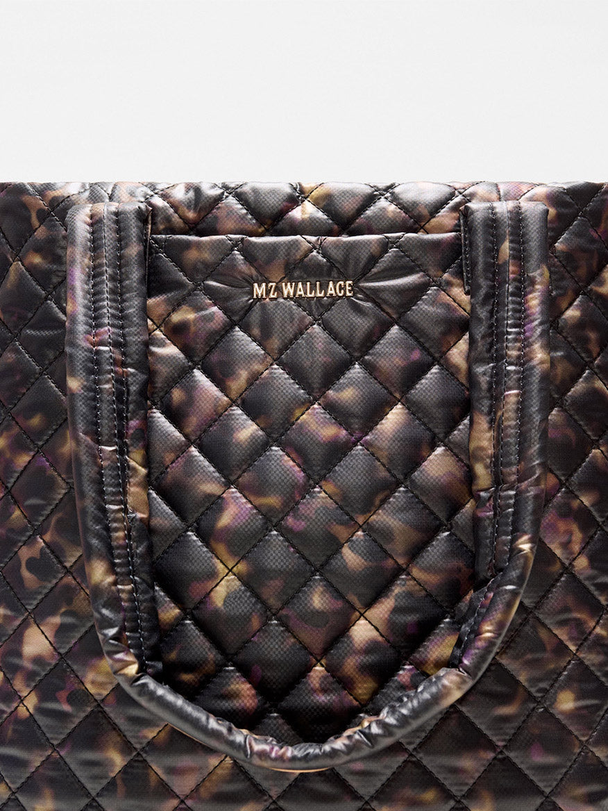 MZ Wallace Medium Metro Tote Deluxe in Tortoise Shell Oxford with black shoulder straps and an exterior slip pocket.
