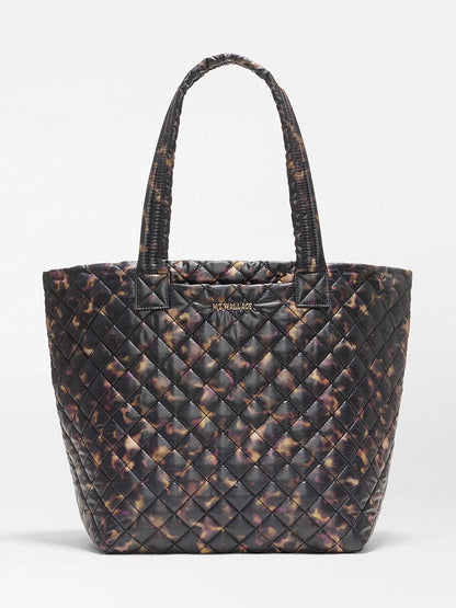 MZ Wallace Medium Metro Tote Deluxe in Tortoise Shell Oxford, a quilted metro tote bag with two shoulder straps and a gold logo plaque on the front.
