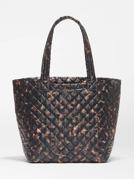 MZ Wallace Medium Metro Tote Deluxe in Tortoise Shell Oxford, a quilted metro tote bag with two shoulder straps and a gold logo plaque on the front.