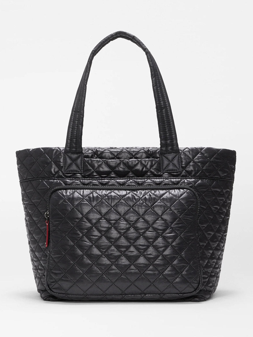 MZ Wallace Medium Metro Travel Tote in Black Oxford—crafted with a quilted design, two handles, and a front zippered pocket—shown against a plain white background; the ideal tote for work and travel.