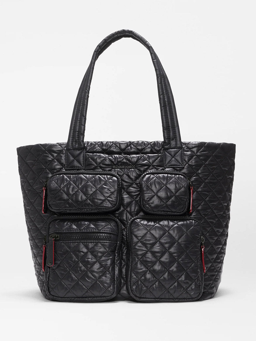 MZ Wallace Medium Metro Travel Tote in Black Oxford—this black quilted tote features two top handles and four front zippered pockets with distinctive red zipper pulls, all crafted from durable black nylon and shown against a plain white background, making it the perfect travel organizer bag.
