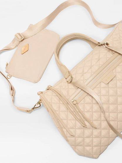 The MZ Wallace Medium Park Satchel in Buff Oxford, displayed on a white background, is a perfect choice for an everyday bag.