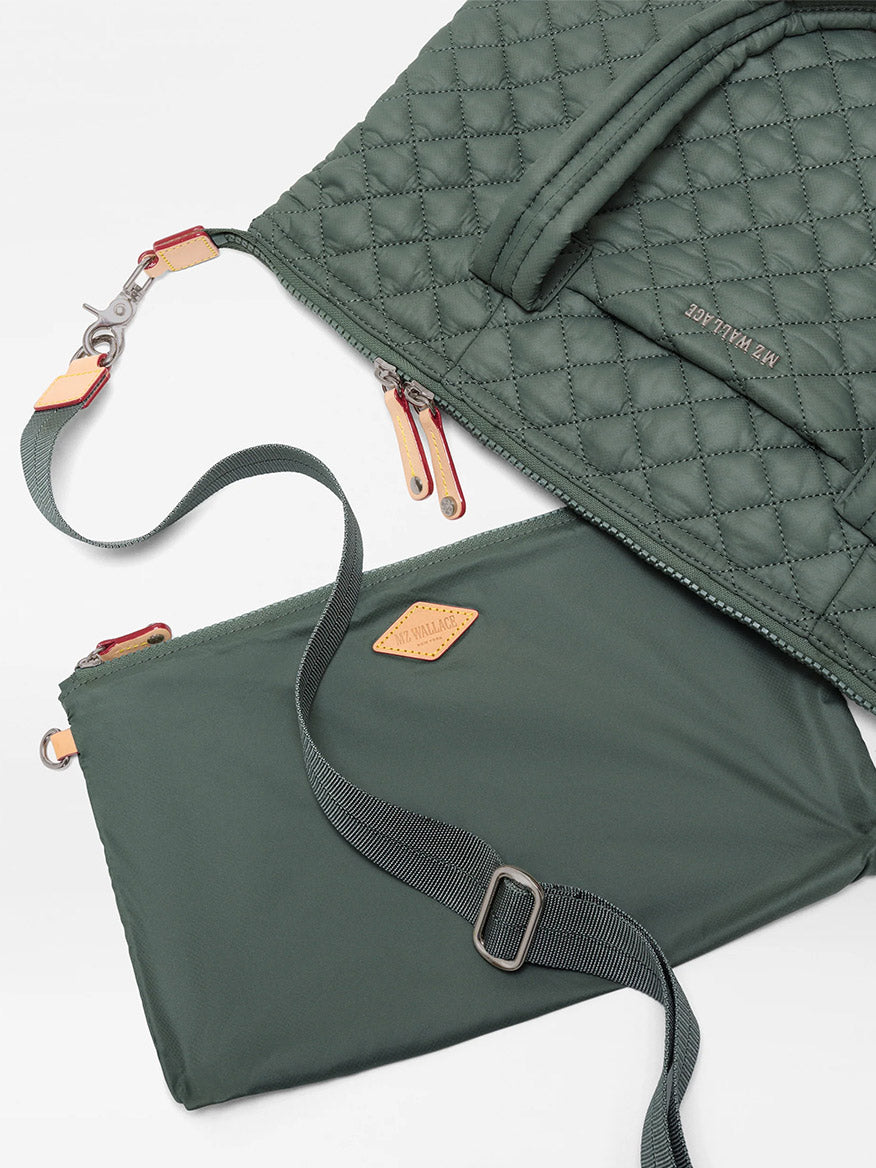 Two green quilted and smooth fabric bags made from recycled Oxford nylon—one being the MZ Wallace Medium Sutton Deluxe in Juniper Oxford—featuring zippers and adjustable straps for structured carry, are laid out on a white background.