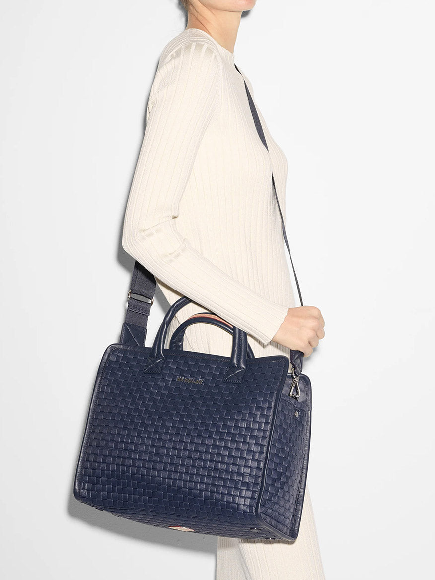 Woman carrying a MZ Wallace Medium Woven Box Tote in Dawn Oxford over her shoulder.