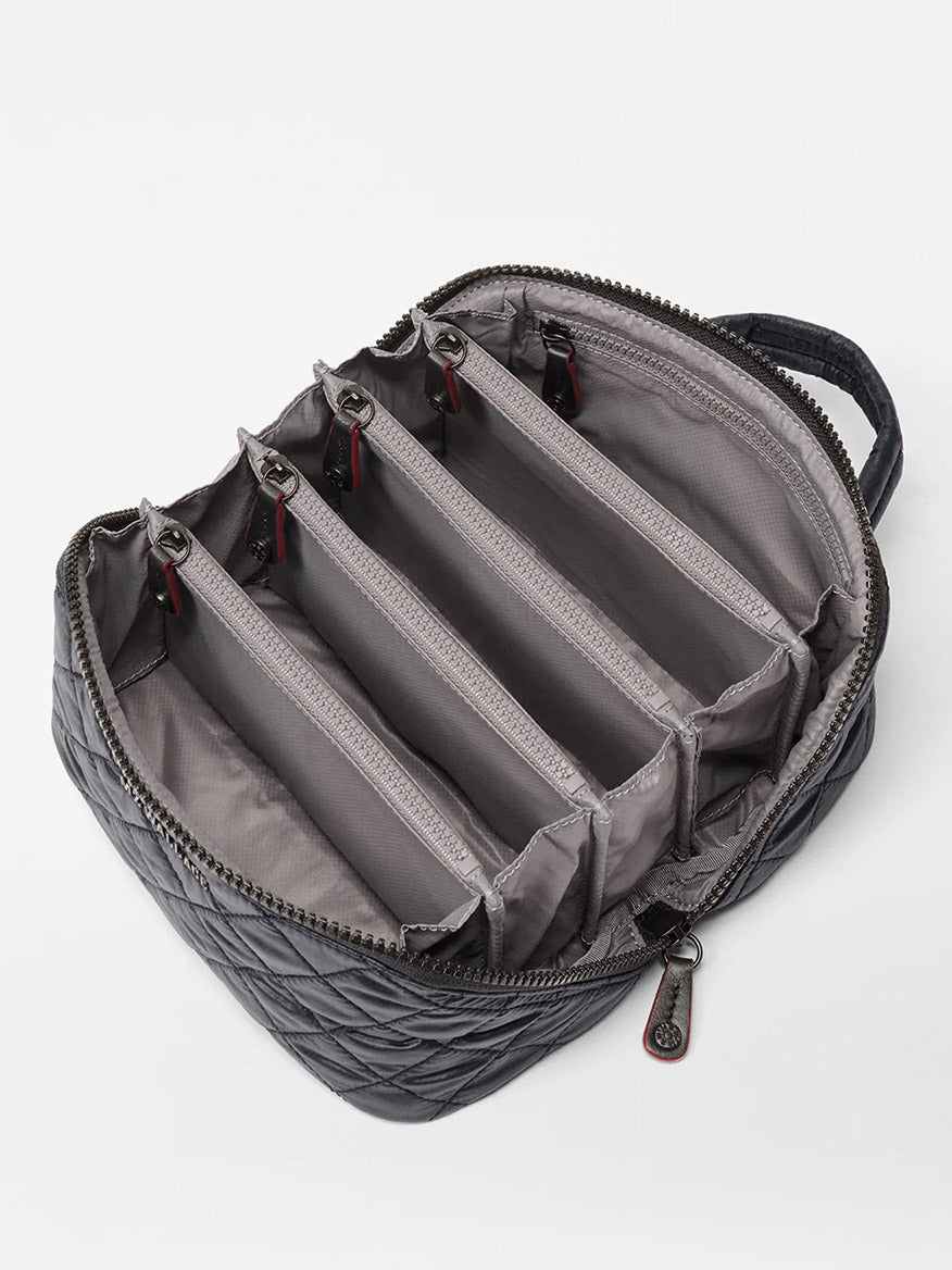 The MZ Wallace Metro Accordion Cosmetic II in Black Oxford is a zippered, quilted bag with a handle, featuring five interior compartments divided by padded separators and finished with refined Italian leather trim.