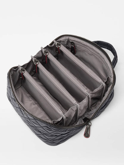 The MZ Wallace Metro Accordion Cosmetic II in Black Oxford is a zippered, quilted bag with a handle, featuring five interior compartments divided by padded separators and finished with refined Italian leather trim.