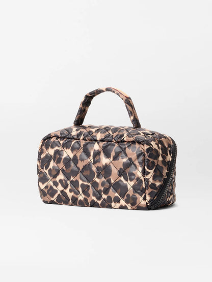 The MZ Wallace Metro Accordion Cosmetic II in Leopard Oxford is a small quilted bag with a handle, brown and black leopard print, interior pockets, and a zipper closure, shown against a plain white background.