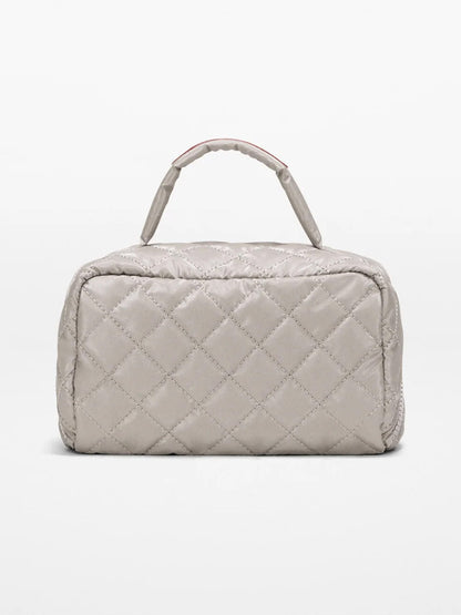 The MZ Wallace Metro Accordion Cosmetic II in Sable Pearl Metallic Oxford, a rectangular quilted bag with a top handle, is shown against a plain white background.