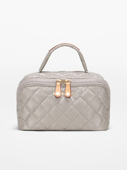 The MZ Wallace Metro Accordion Cosmetic II in Sable Pearl Metallic Oxford features a quilted light gray design, top handle, two gold zippers, and Italian leather elegance, shown on a plain white background.