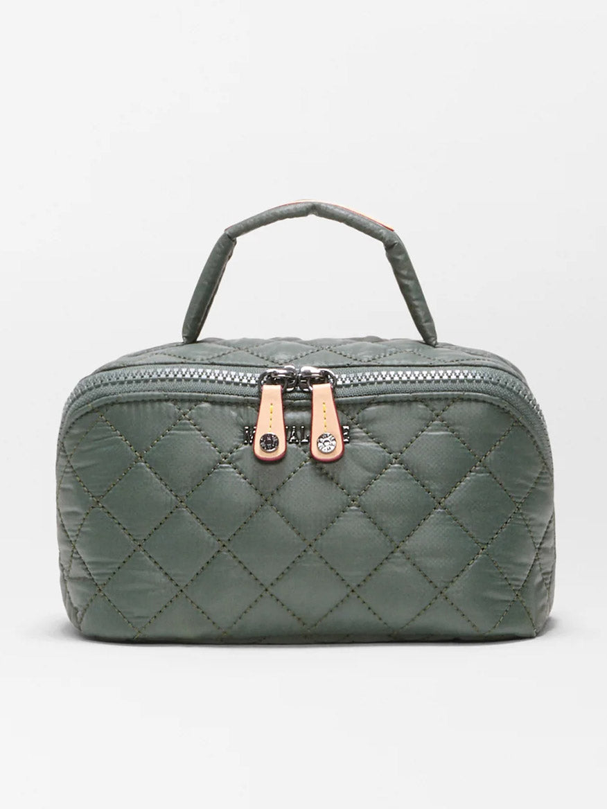 The MZ Wallace Metro Accordion Cosmetic II in Juniper Oxford is a quilted green rectangular bag made from recycled Oxford nylon, featuring two beige zipper pulls and a short top handle. Shown against a plain white background, it’s the perfect cosmetic organizer for everyday essentials.