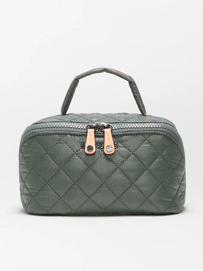 The MZ Wallace Metro Accordion Cosmetic II in Juniper Oxford is a quilted green rectangular bag made from recycled Oxford nylon, featuring two beige zipper pulls and a short top handle. Shown against a plain white background, it’s the perfect cosmetic organizer for everyday essentials.