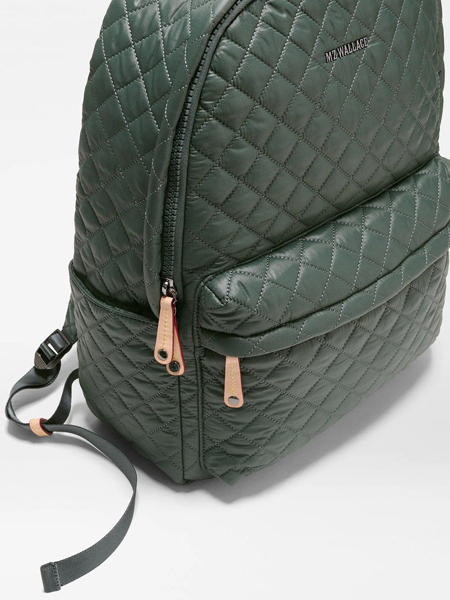 The MZ Wallace Metro Backpack II in Juniper Oxford, crafted from recycled Oxford nylon with tan zipper pulls and a front pocket, is shown on a white background.