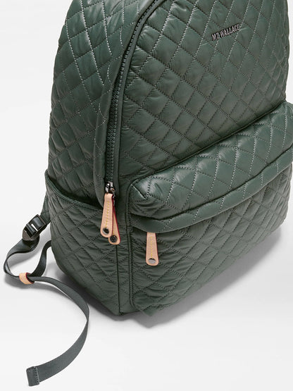 The MZ Wallace Metro Backpack II in Juniper Oxford, crafted from recycled Oxford nylon with tan zipper pulls and a front pocket, is shown on a white background.
