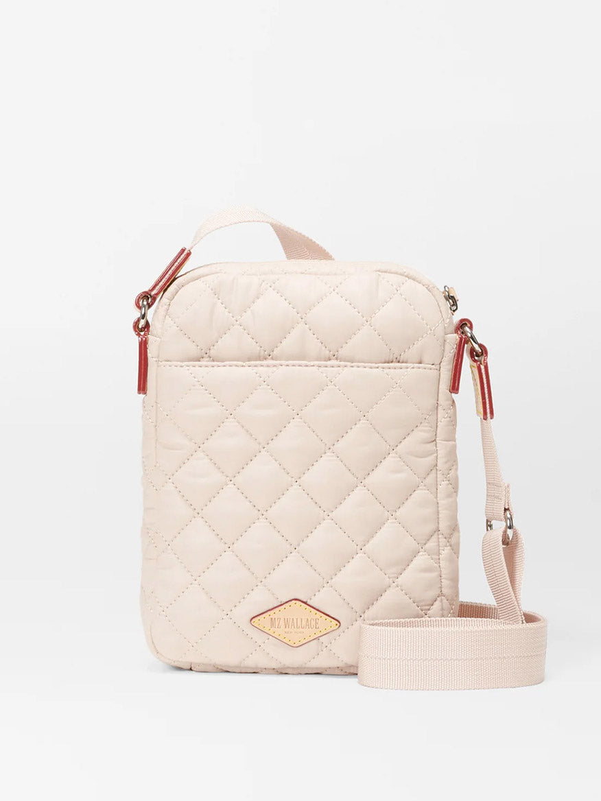 Quilted Mushroom Oxford MZ Wallace Metro Crossbody bag with red zipper accents and a brand logo on the front, featuring an adjustable nylon crossbody strap.