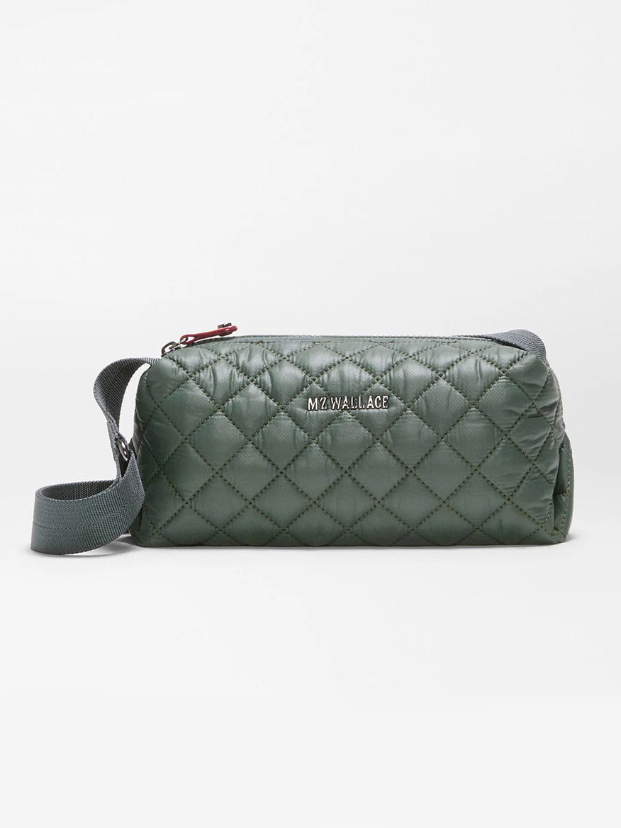 Introducing the MZ Wallace Metro East West Crossbody in Juniper—a compact, quilted green bag crafted from recycled nylon and accented with a gray strap and a silver “MZ WALLACE” logo on the front, photographed against a plain white background. It’s perfect as an everyday crossbody.
