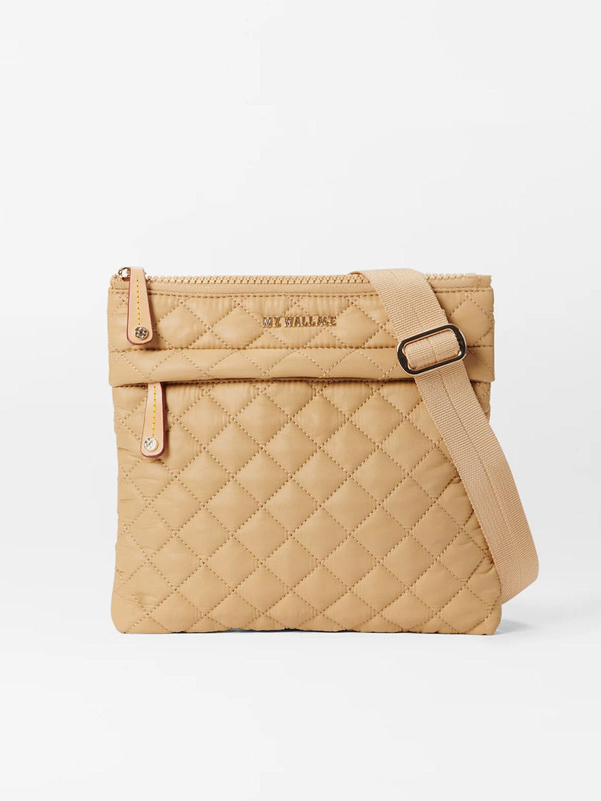 Beige quilted MZ Wallace Metro Flat Crossbody in Camel Oxford with a zip closure, exterior pockets, and adjustable strap, displayed against a plain white background.