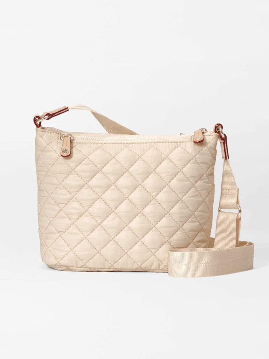 The MZ Wallace Metro Scout Deluxe in Buff Oxford is a beige quilted crossbody bag made from fine Italian leather, with a rectangular shape, gold-tone hardware, and an adjustable fabric strap on a plain white background.