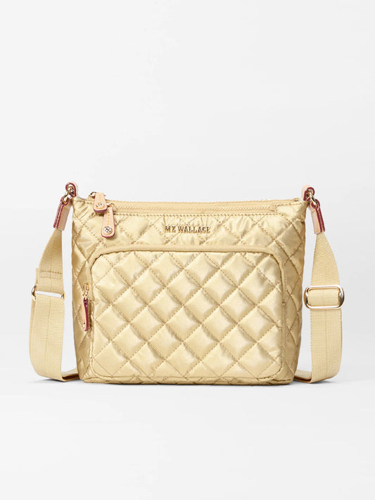The MZ Wallace Metro Scout Deluxe in Light Gold Pearl Oxford is a quilted crossbody with Italian leather trim, front zip pocket, adjustable strap, and gold-toned hardware, displayed against a white background.