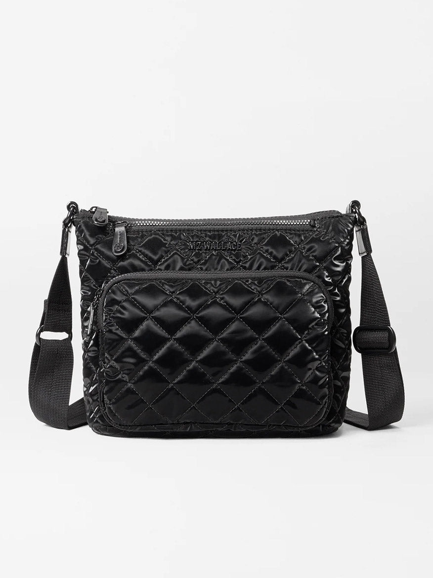 The MZ Wallace Metro Scout Deluxe in Black Liquid Oxford crossbody bag, made from Italian leather, showcases a black quilted design with a front zipper pocket and an adjustable strap for easy styling.